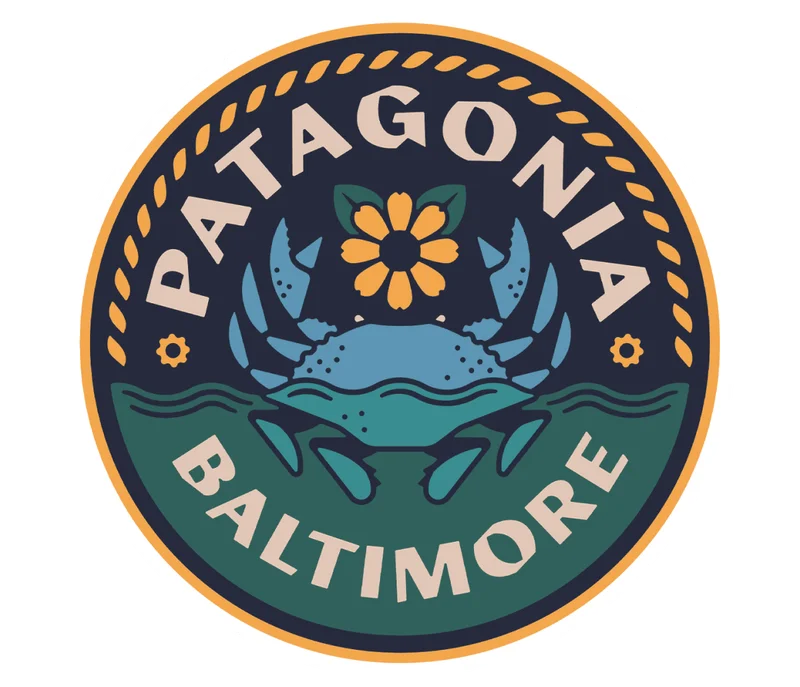 A Patagonia Baltimore store logo with a blue crab.