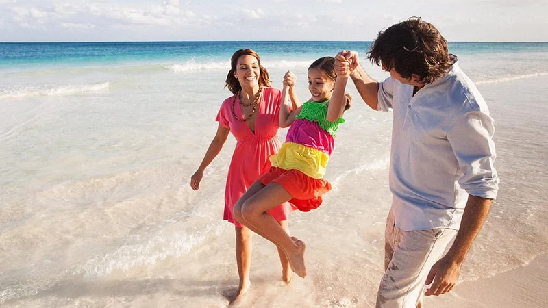 Image description: Family of three walking on beach in Puerto Rico