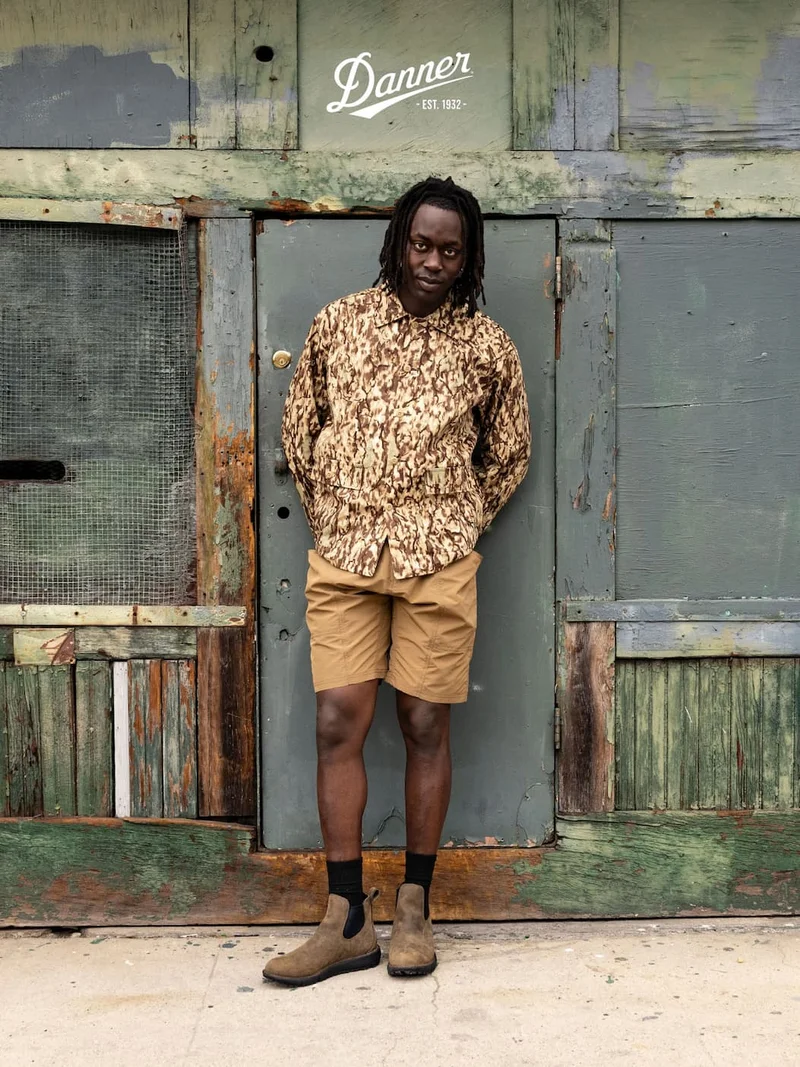 Person standing in front of a building wearing a pair of Tramline Chelsea 917 GTX boots in the color Major Brown