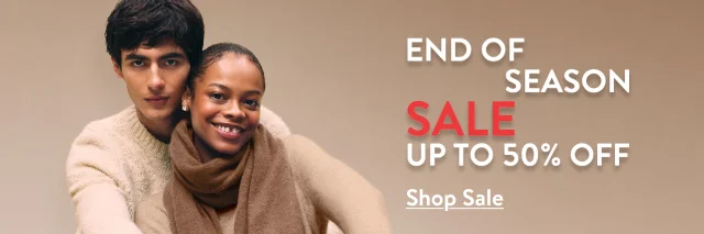End-of-season sale: up to 50% off. A woman and man wearing cozy knitwear.