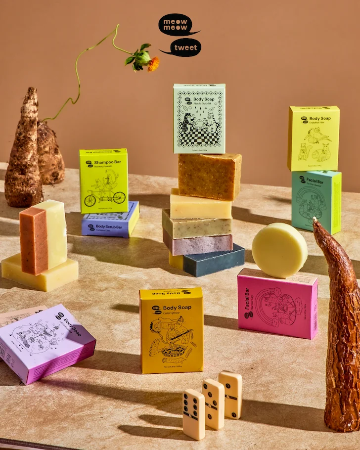A colorful collection of bar soaps on a brown and tan background