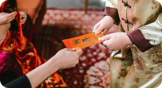 Traditional celebrations include eating longevity noodles and giving red envelopes with money for good fortune.
