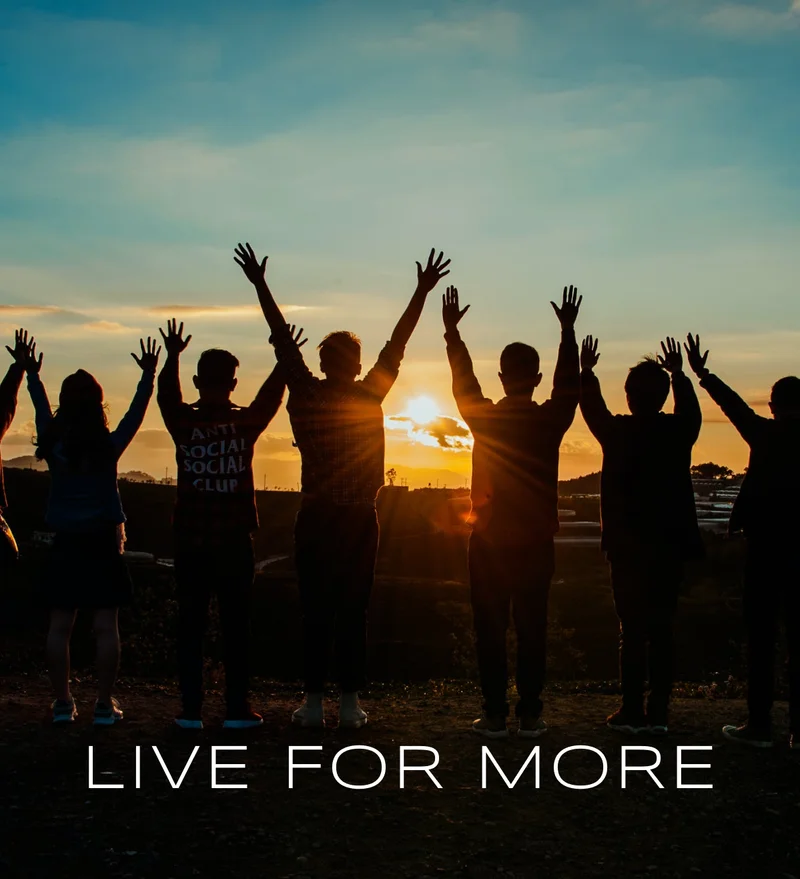 Live For More - a group of people raising their hands to the sun rise