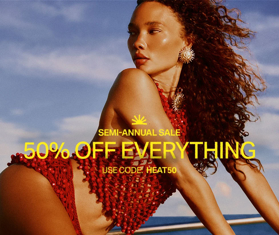 Woman in red beaded swimwear and sun earrings against a clear blue sky, advertising a 50% off everything summer fashion sale. Code: discount code.
