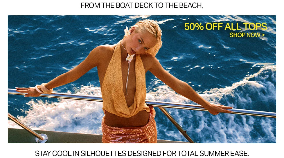Stylish woman in a golden halter top and peach skirt on a boat, blue ocean background, promoting 50% off summer tops sale.