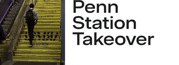 Animated scene of commuters walking up stairs at Penn Station with ARMRA branding on the steps.