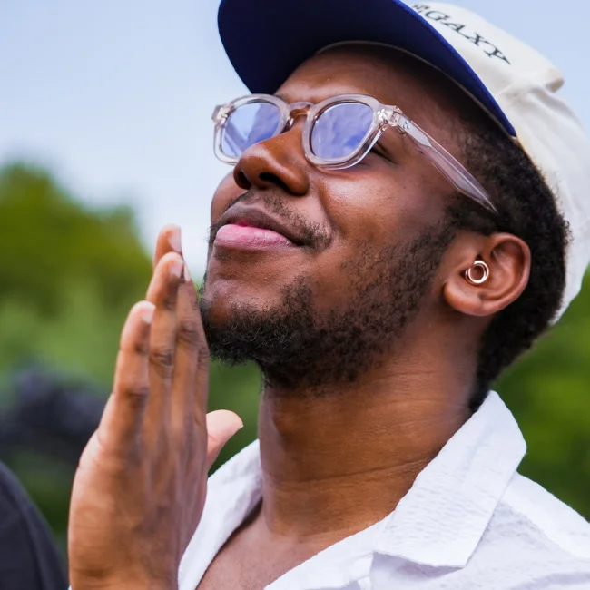 A man wearing Loop earplugs dancing happily at a festival.