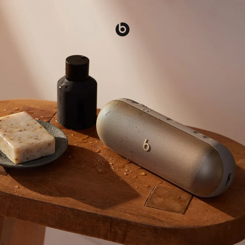 Beats Pill sitting on a bath stool showcasing it's water-resistant feature