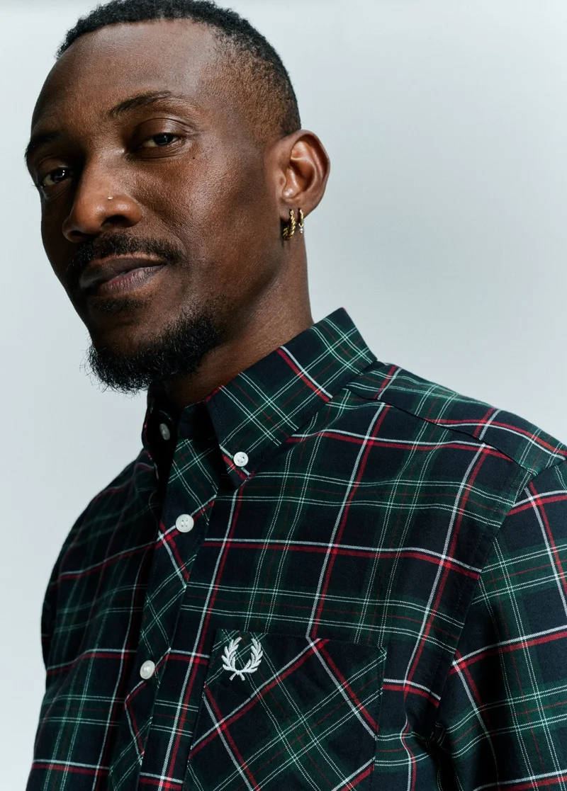 Male model wearing an exclusive tartan shirt from the Only At Fred Perry collection.