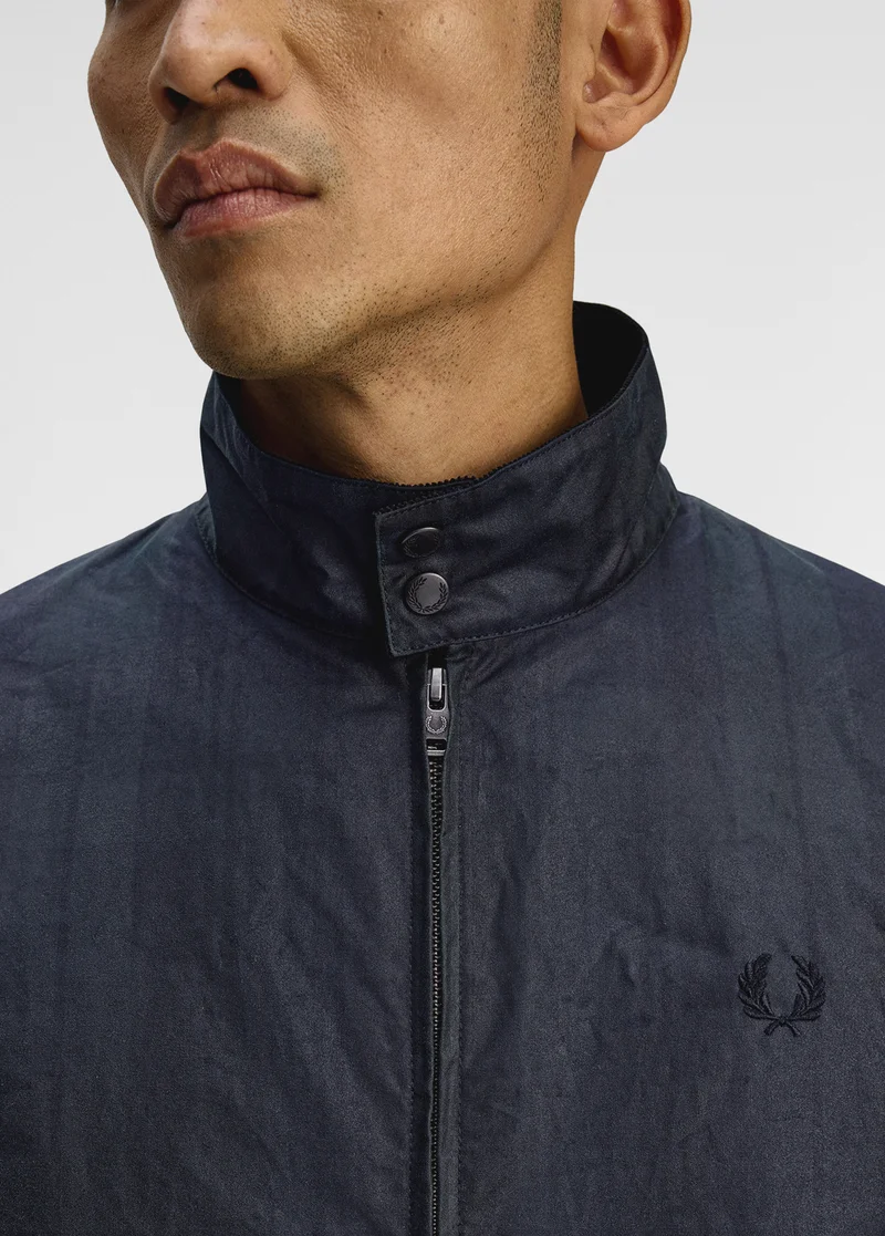 Male model wears a navy zipped up Fred Perry jacket with collar
