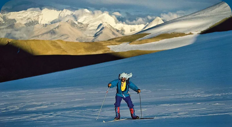 A person skate skiing in a remote mountainous landscape.