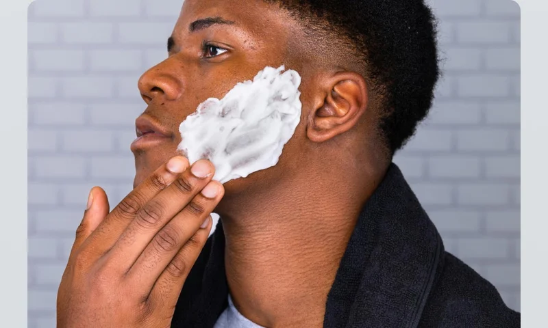 Man applies shaving gel to his face Man applies shaving gel to his face