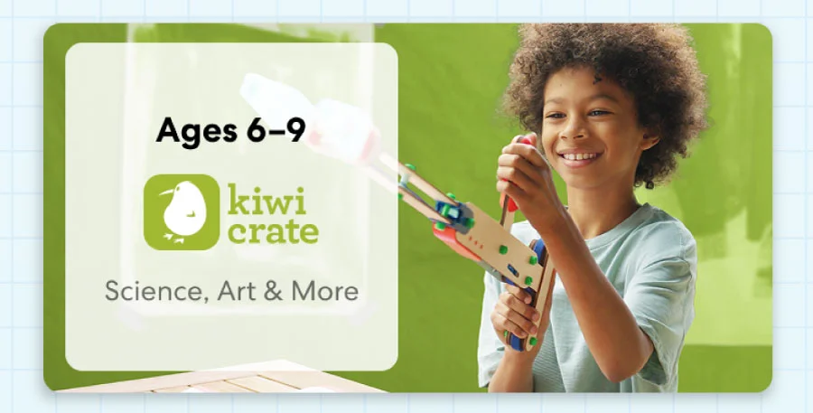 Young child smiling while working on a science experiment from KiwiCo Labs. Hands-on STEM learning for ages 6–9