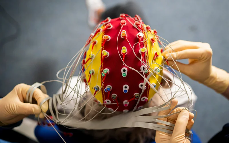 An electroencephalography (EEG) cap measures the brain’s electrical activity during sleep and wakefulness, helping scientists study how sleep affects memory, mood, and brain health.
