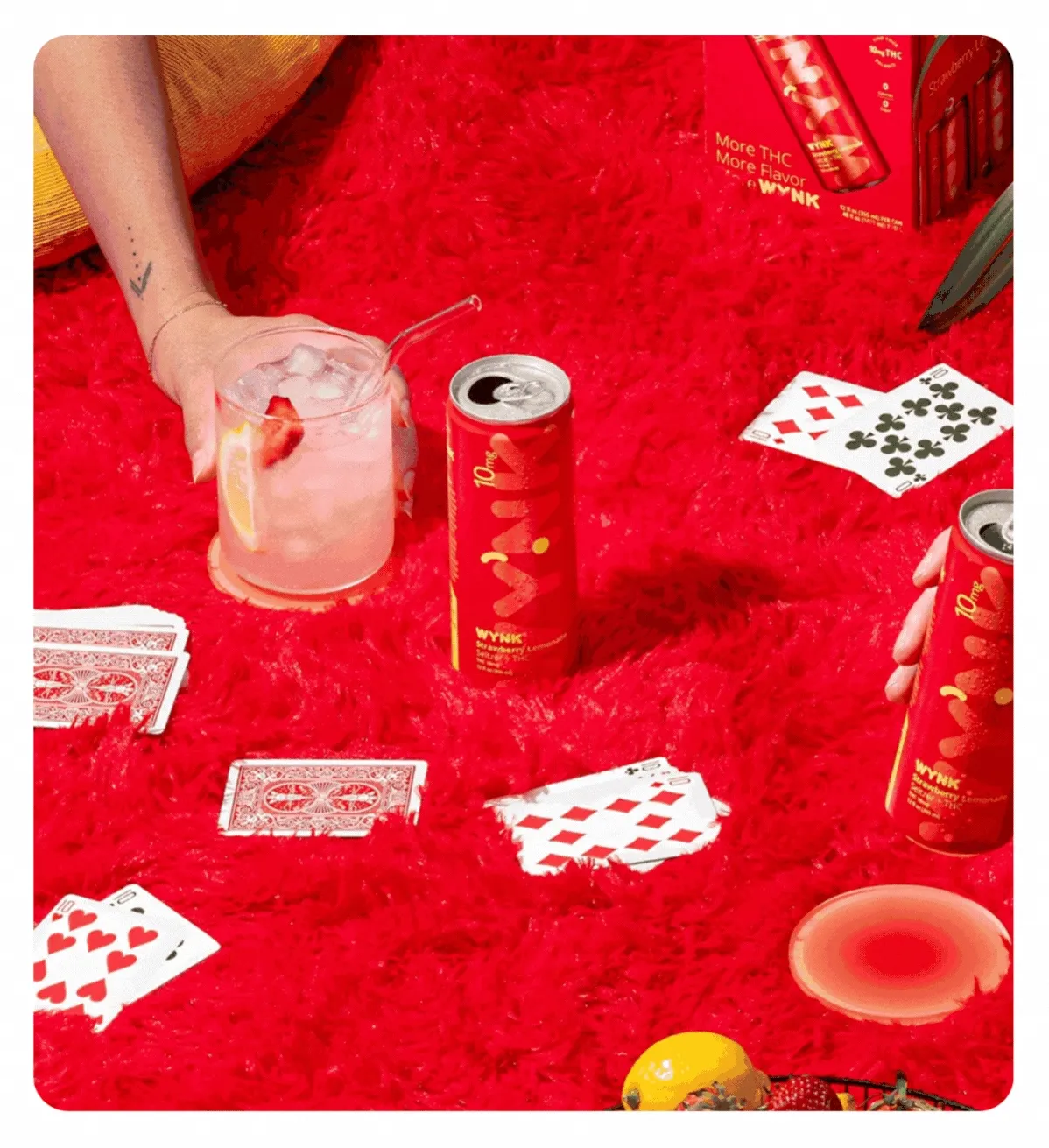 (Red can of Wynk Strawberry Lemonade 10mg Seltzer in hands with friends and looking delicious.)