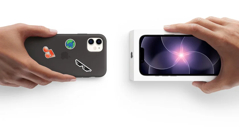 Hands of two different people exchanging a used iPhone with a new iPhone