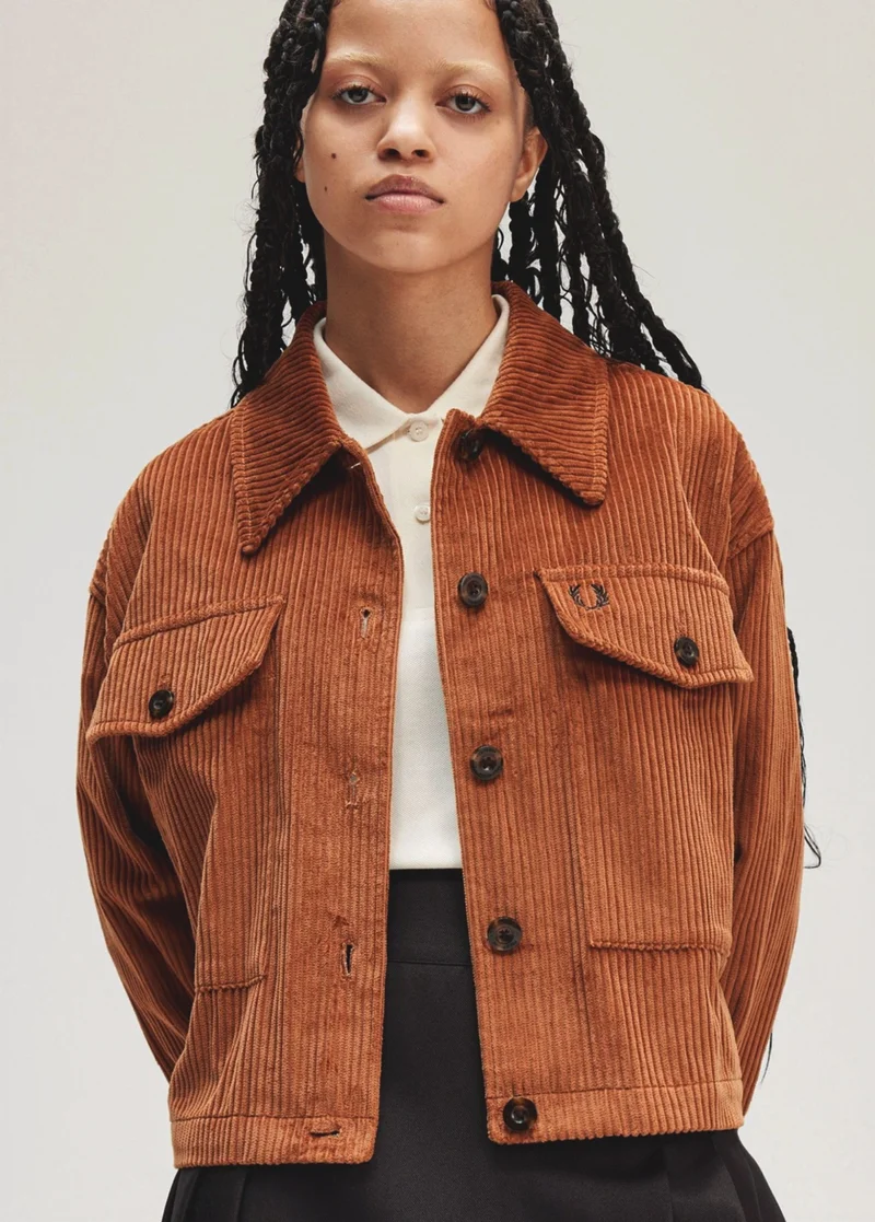 A female model wears a Cord Overshirt in Marmalade