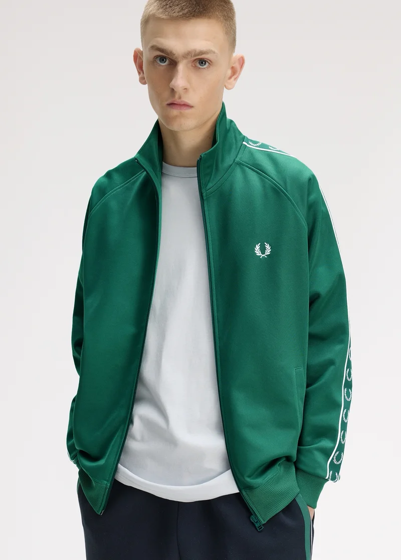 Male model wearing a Fred Perry Contrast Tape Track Jacket in Sport Green
