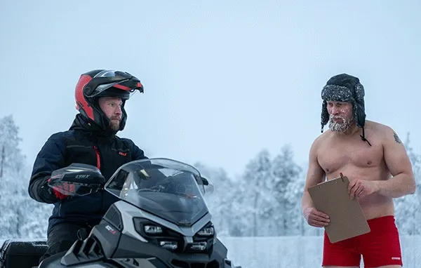 People outdoors with Lynx snowmobiles