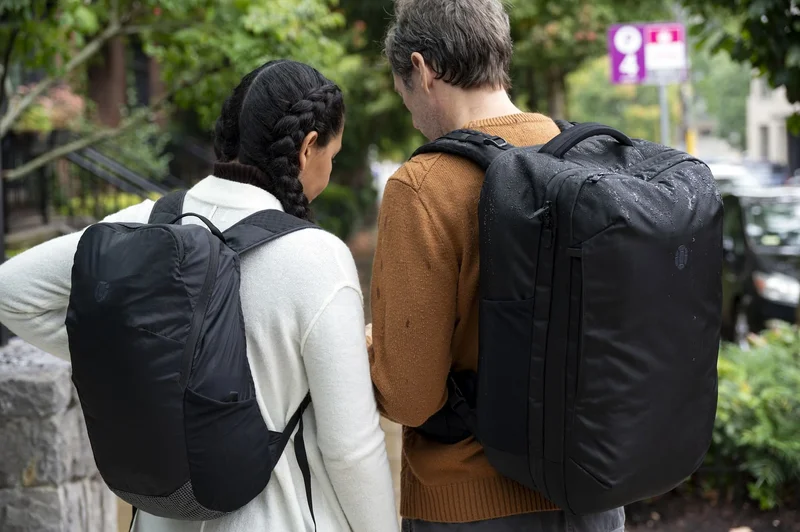 Couple wearing backpacks and reading a map