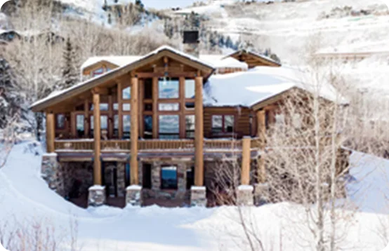 Escape to a cozy ski chalet blanketed in snow in Park City, Utah.