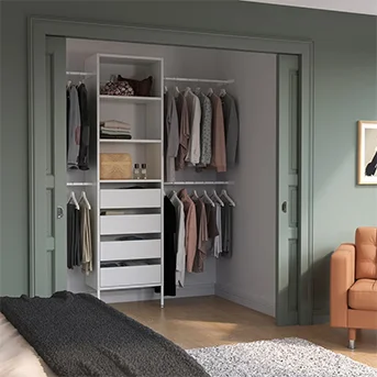 Open white AURDAL wardrobe in a green room