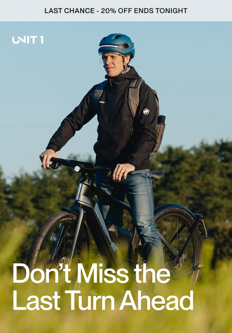 Man wearing UNIT 1 smart helmet and riding an e-bike at golden hour with a backpack — "Last chance to save 20%"