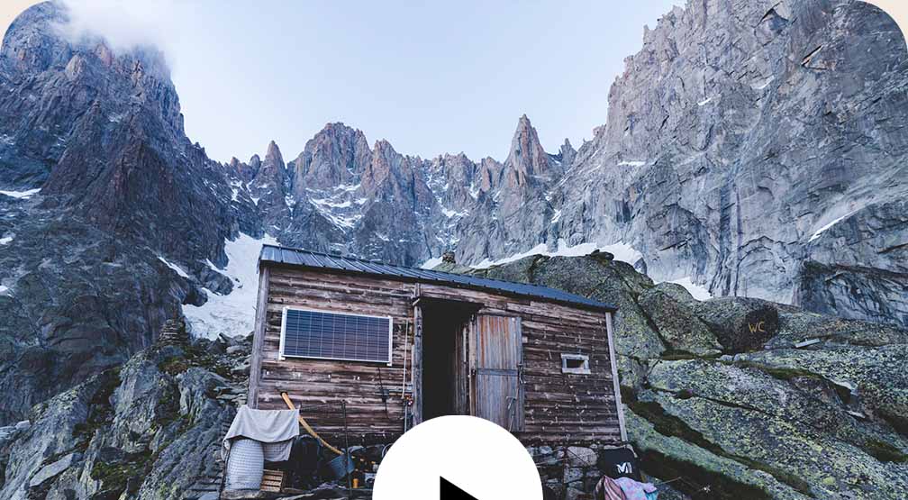 A rustic mountain hut perched on a ridge high in the French Alps.