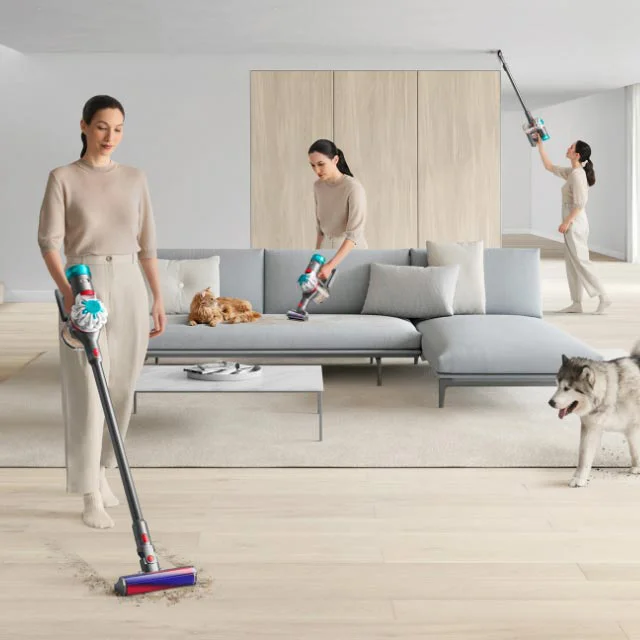 A woman cleaning living room with Dyson V8 Absolute cordless vacuum