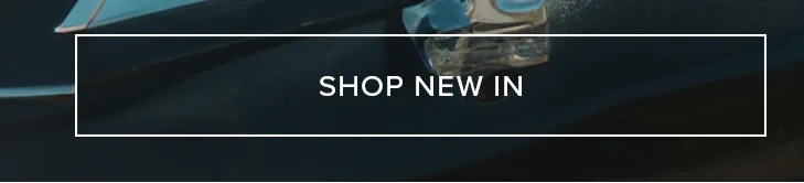 "SHOP NEW IN" button, white text on dark blue background with subtle teal accents, encouraging users to discover new arrivals and latest collection.