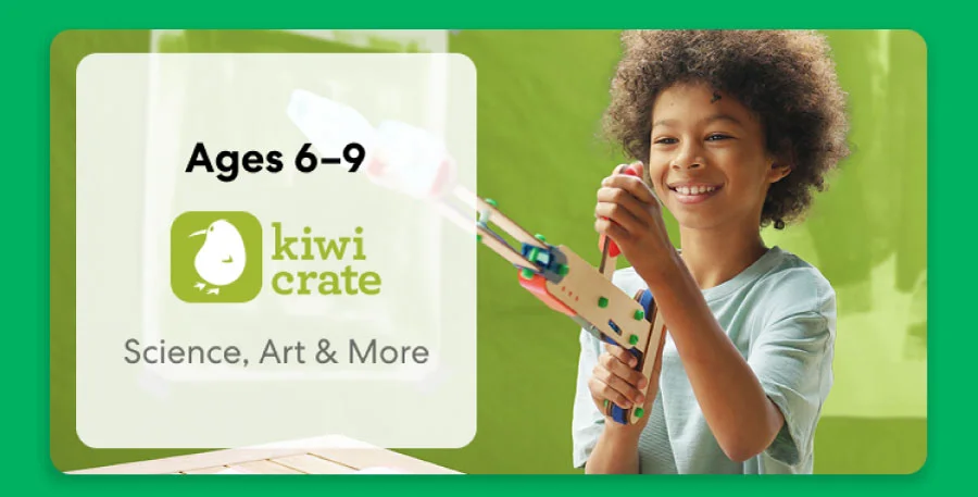 Young child smiling while working on a science experiment from KiwiCo Labs. Hands-on STEM learning for ages 6–9