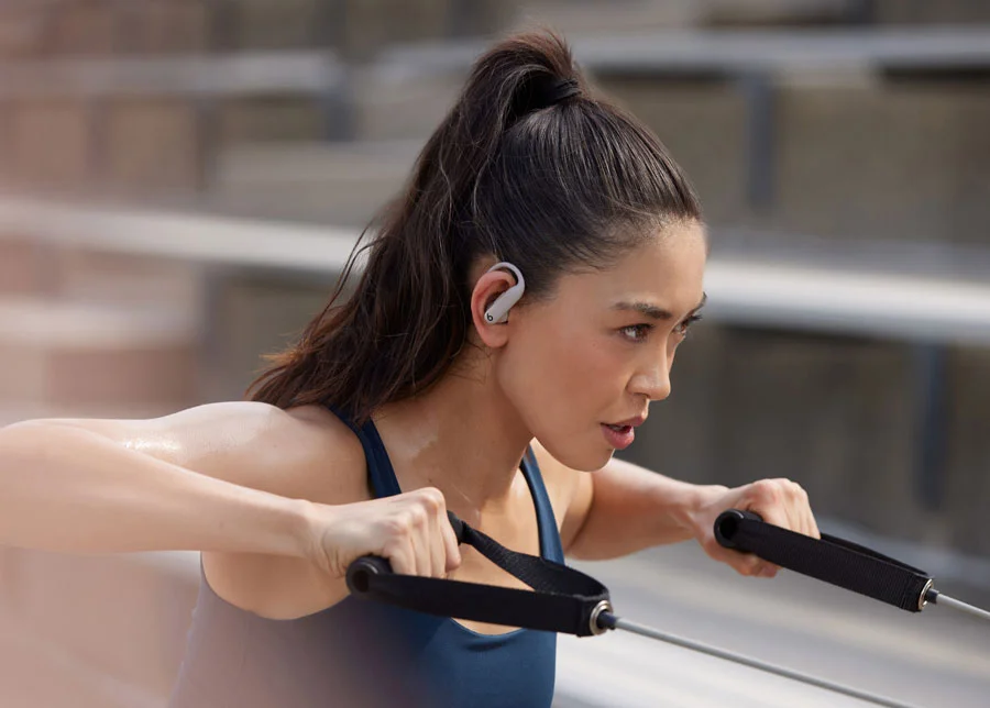 Woman wearing Powerbeats Pro 2 while working out to demonstrate secure fit.