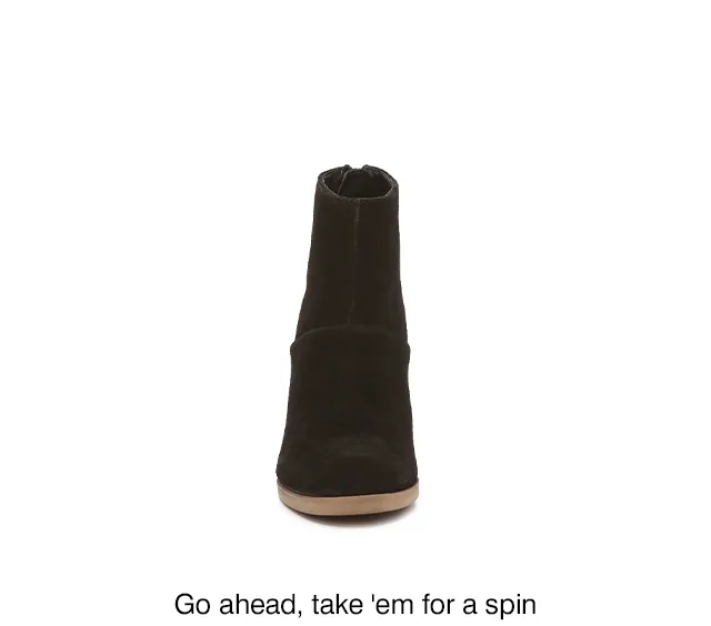 Black suede bootie rotating to show almond toe, block heel and back tassel. Shop the Ingrid.