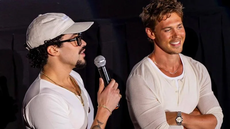 Image may contain: Austin Butler, Bad Bunny, Electrical Device, Microphone, Accessories, Bracelet, Jewelry, Adult, and Person