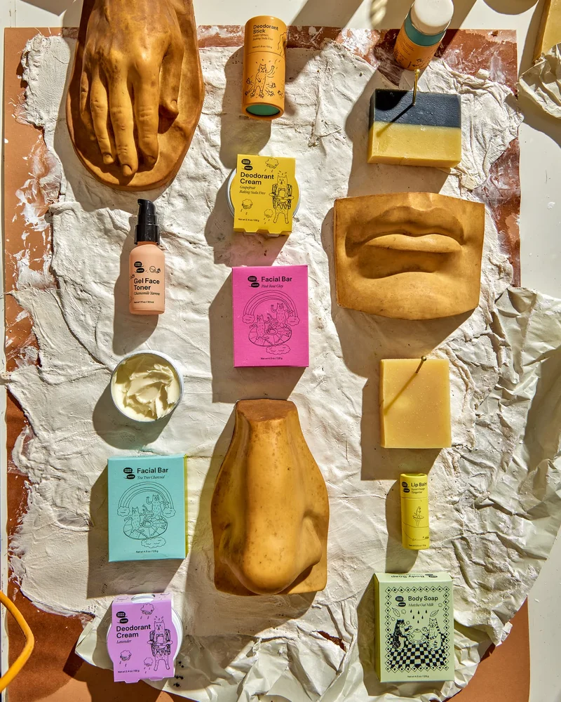 A collection of products is arranged with ceramic body parts on a messy table