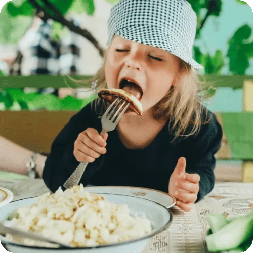 a kid eating veggies thanks to a nutritionist's tip a kid eating veggies thanks to a nutritionist's tip