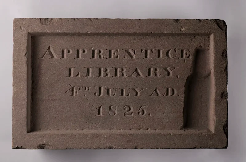 A piece of limestone that reads “Apprentice Library, 4th July AD 1925”