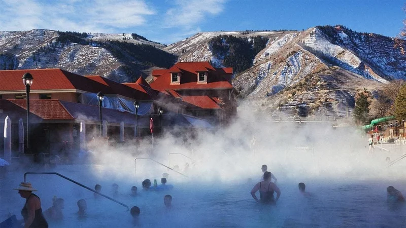 Image description: People soaking in the hot springs at Glenwood Springs, Colorado.