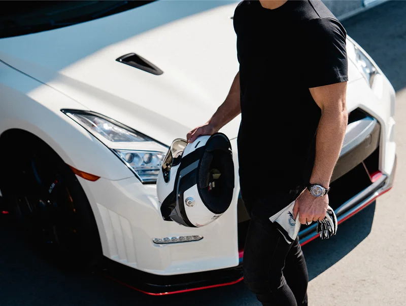 Person wearing the Tsuno Chrono Racer walking by a white car