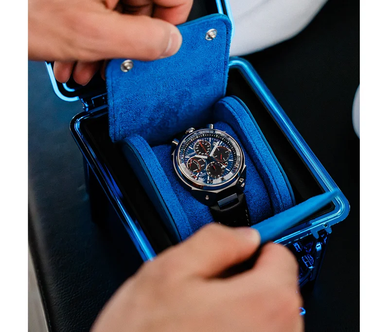 Image of the Tsuno Chrono in a custom Blue Chrome Promaster Tackle Box with a leather watch roll.