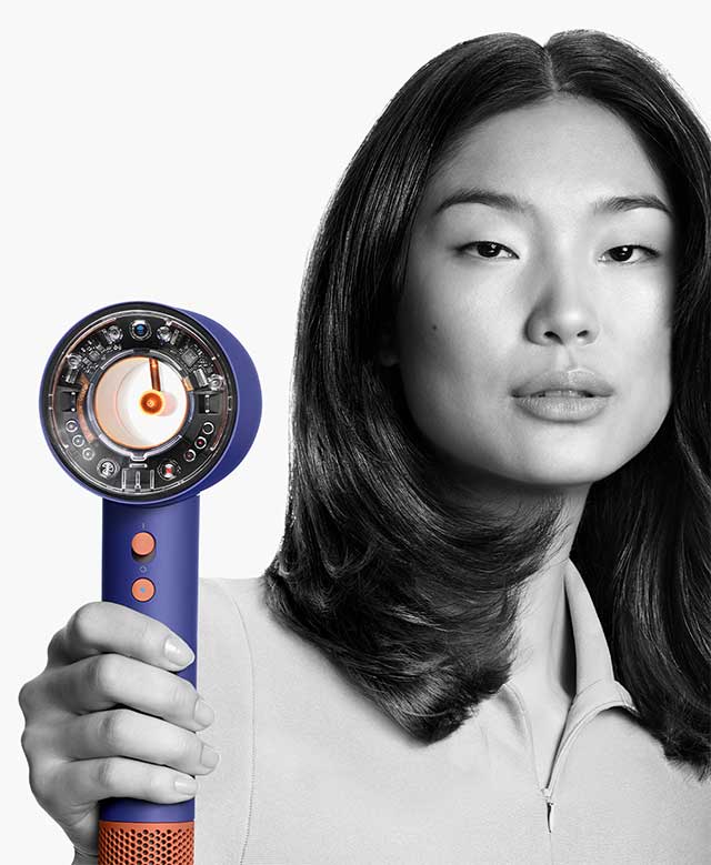 Female model using the Dyson Supersonic Nural hair dryer