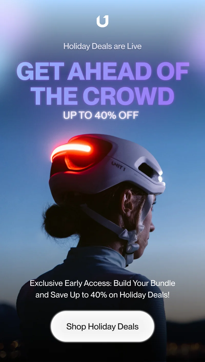 Man wearing a bike helmet with integrated lights.