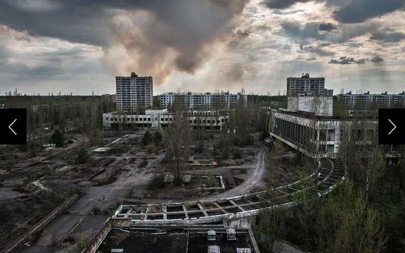 A plume of smoke from a forest fire rises beyond the ghost town of Pripyat, where workers and the families of the Chernobyl nuclear power plant once lived.