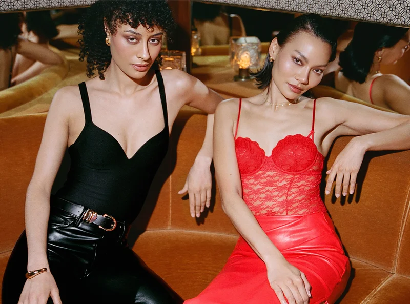 Models wearing the Zero-G Lift Up Bodysuit in Black and Effortless Lace Teddy in Cherie
