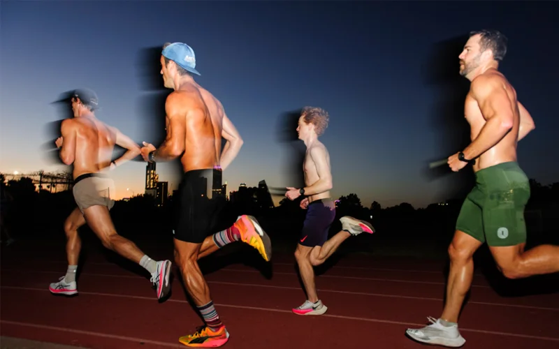 Four men run on a track.