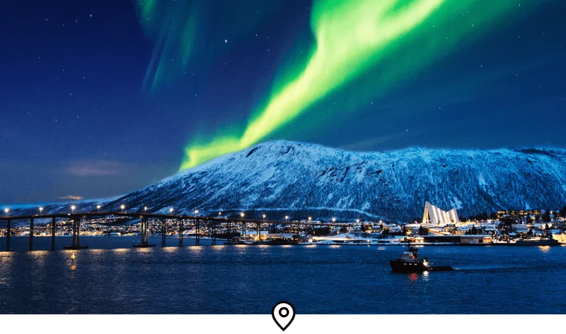 Image Description: A bright green streak of light above the Tromsø port in Norway