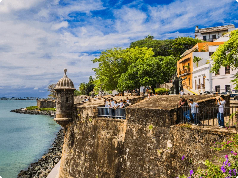 Image Description: Travelers exploring a historic fort by the sea at Old San Juan in Puerto Rico