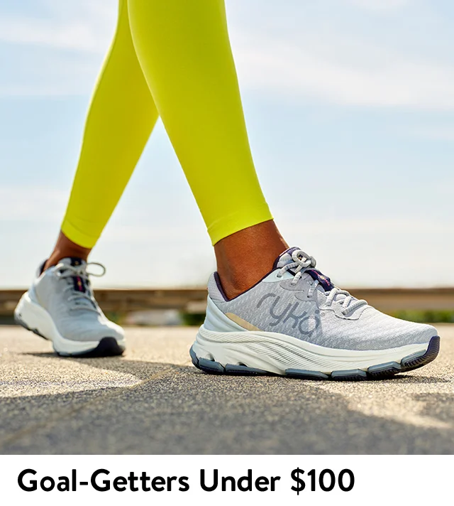 A woman walking in a pair of sneakers.