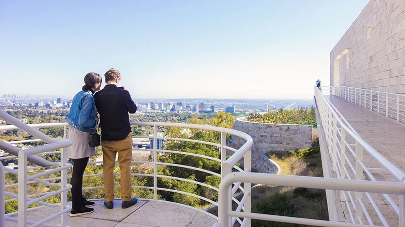Image description: A couple looking at the view from The Getty Center, Los Angeles