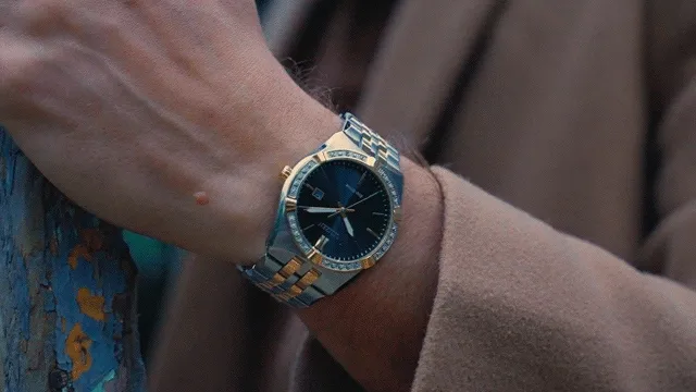 Person putting on a coat and wearing a Corso watch.